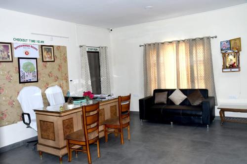 a living room with a table and a couch at Rameshwarm Resort in Mukteswar