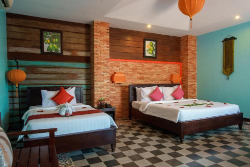 two beds in a room with blue and red at RESIDENCE 1960 in Siem Reap