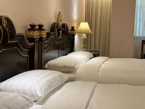 a group of four beds in a hotel room at Grand Pleasure Spring Hotel in Taipei