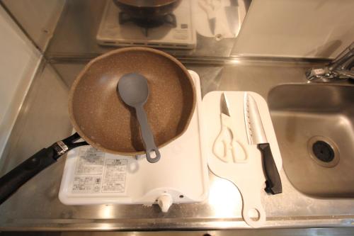 a pan with a spoon on top of a stove at LUANA in SHIBUYA in Tokyo