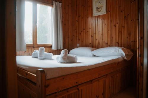 a bedroom with a bed with white sheets and pillows at Camping Alquézar in Alquézar