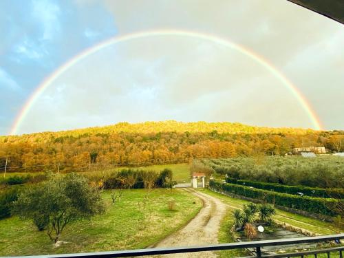 a rainbow in the sky over a dirt road at Anna&Franco Guest House in Isernia