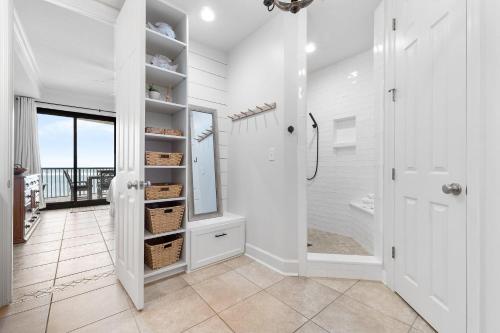 baño blanco con ducha y vestidor. en Grand Pointe 401 en Orange Beach