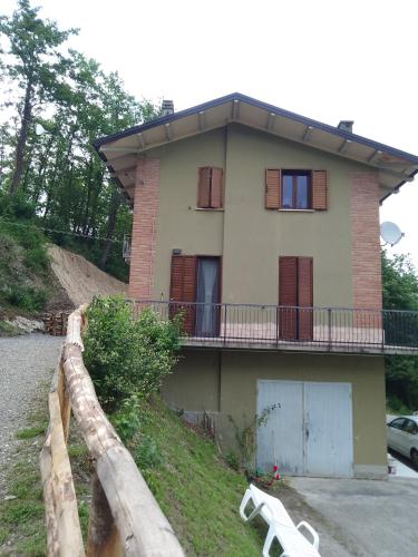 a house with a fence in front of it at Casa Artemis (Artemis House) in Cerreggio