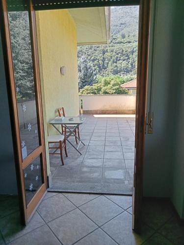 a room with a view of a patio with a table at La Casa di Elisa Affittacamere in Gravellona Toce