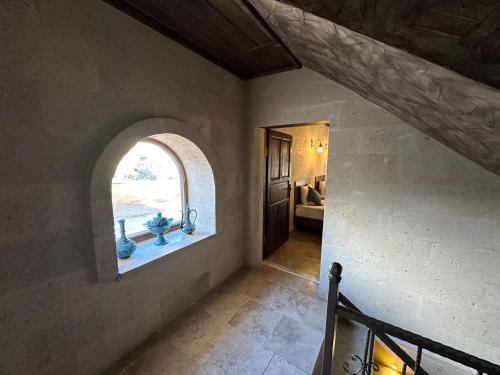 an archway in a room with a window at Virtus Cappadocia Hotel Göreme in Goreme