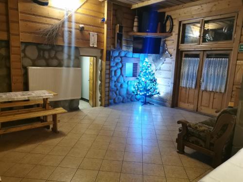 a christmas tree in a room with a fireplace at Domek u Stocha in Poronin