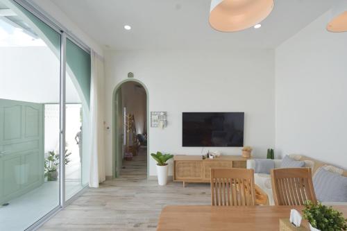 a living room with a couch and a table at Self house (Cozy private house) in Hat Yai