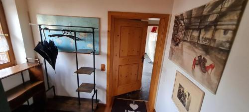 a hallway with an open door and an umbrella at Koasablick in Ebbs