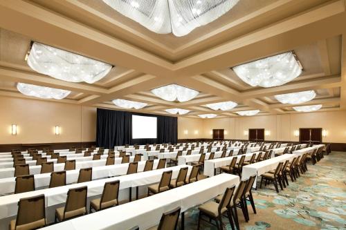 an empty conference room with rows of tables and chairs at The Westin San Francisco Airport in Millbrae