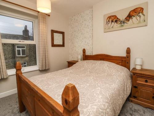 En eller flere senge i et værelse på The Robins Holiday Cottage