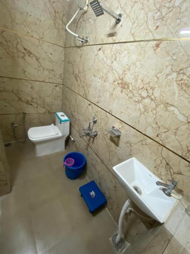 a bathroom with a sink and a toilet at Shree Govindam Guest House in Ujjain