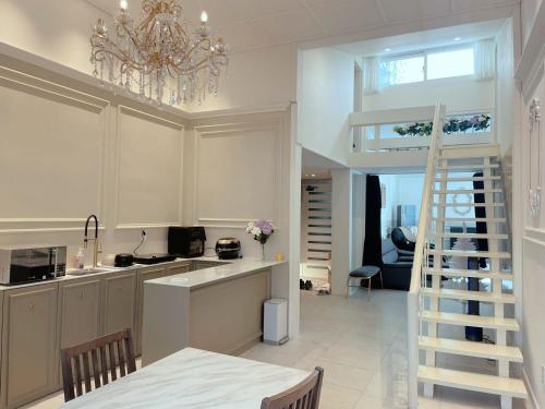 a kitchen with a chandelier and a staircase in it at ypark in Seoul