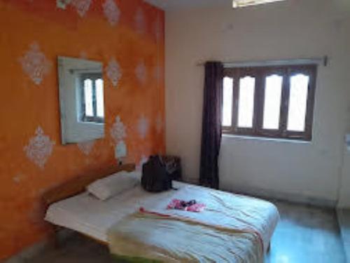 a bedroom with a bed and a window at Hotel Maurya Vihar Bodhgaya in Bodh Gaya