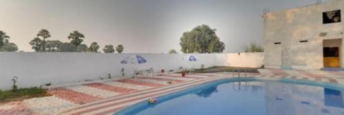 a large swimming pool in front of a building at Hotel Maurya Vihar Bodhgaya in Bodh Gaya