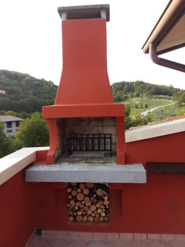 an outdoor fireplace on the roof of a house at La Torretta - incantevole appartamento nei colli Berici in Nanto