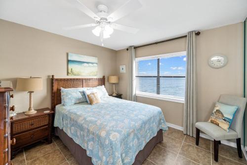 1 dormitorio con 1 cama, 1 silla y 1 ventana en Sunswept 806, en Orange Beach