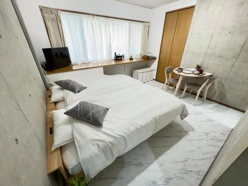 Ένα ή περισσότερα κρεβάτια σε δωμάτιο στο ストレッチ西落合104