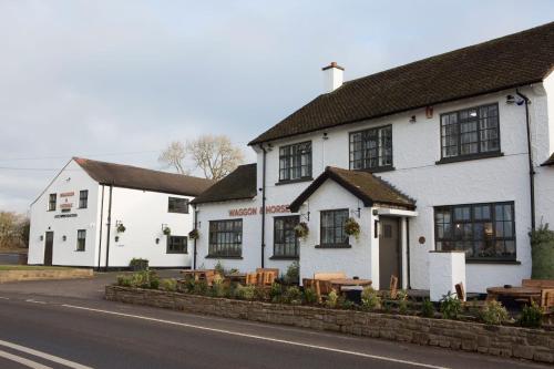 a couple of white buildings on the side of a street at Waggon and Horses, Eaton, Congleton in Eaton