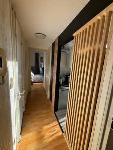 a hallway with a door leading to a kitchen at ALINE GRAND HOTEL in Capvern