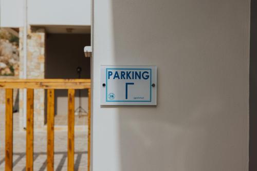 a sign on a wall with a parking sign on it at 2S Villas Resort in Sivota