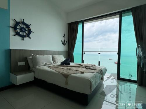 a bedroom with a bed with a view of the ocean at Full Seaview 3BR 3BD Duplex Apartment 房间全面向海景-3房 3卫 复式公寓 in Port Dickson