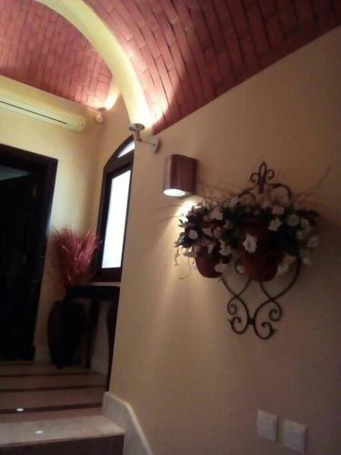 a hallway with a flower pot on the wall at Villa with 2 Bedrooms Sea View and Garden with private Pool in Ras al Khaimah