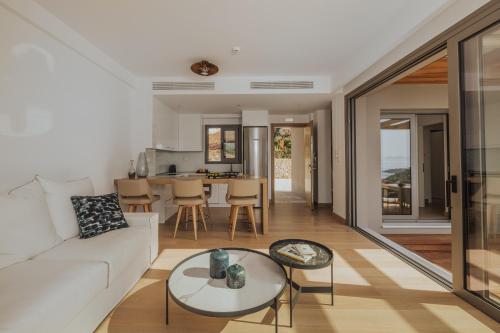 a living room with a white couch and a table at 2S Villas Resort in Sivota