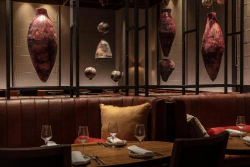 a restaurant with two tables and wine glasses at Next Hotel Melbourne, Curio Collection by Hilton in Melbourne