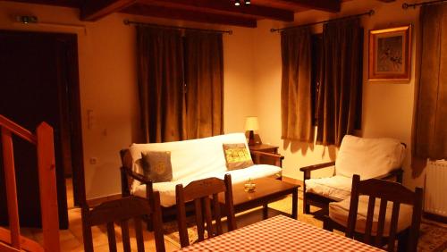 a living room with a bed and a table and chairs at Mont Valley Boutique Chalets in Arachova