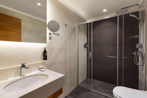 a bathroom with a sink and a shower at Days Inn by Wyndham Istanbul Bomonti in Istanbul