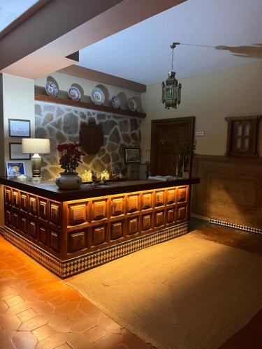 a living room with a counter with a stone wall at Hotel Barbacedo in Mijares