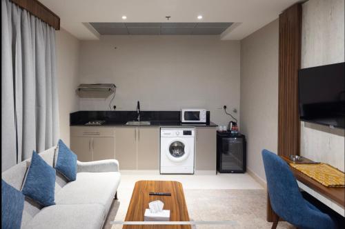 a living room with a couch and a washing machine at Sweet Home For Serviced Accommodation in Jeddah