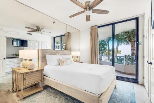 a bedroom with a bed and a large window at East Pass 102 in Destin
