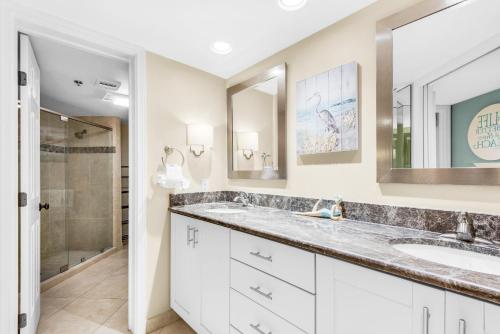 a bathroom with two sinks and a shower at East Pass 102 in Destin
