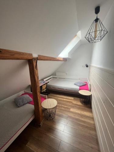 a room with two bunk beds and a ladder at Apartamenty Kadłubek in Wisła