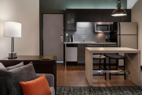 a kitchen with a table and a kitchen with a refrigerator at Residence Inn by Marriott Boston Downtown Seaport in Boston