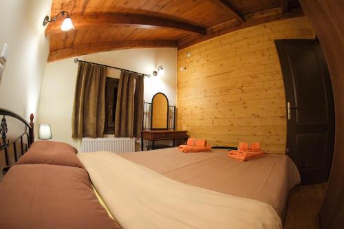 a bedroom with two beds in a room with wooden walls at Mont Valley Boutique Chalets in Arachova