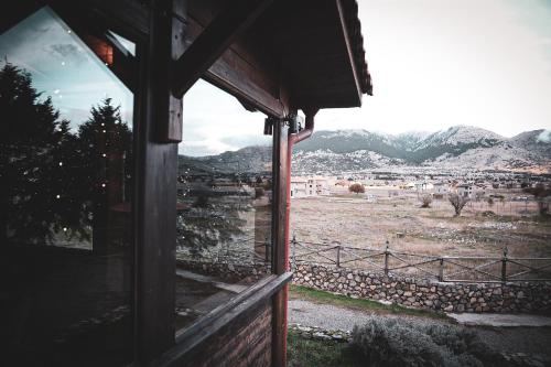 a window of a house with a view of a field at Mont Valley Boutique Chalets in Arachova