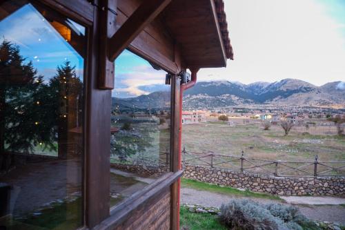 a window of a house with a view of the mountains at Mont Valley Boutique Chalets in Arachova