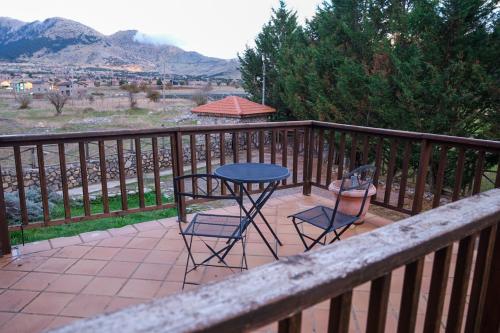 a patio with two chairs and a table on a balcony at Mont Valley Boutique Chalets in Arachova