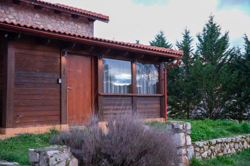 a small cabin with a window and a door at Mont Valley Boutique Chalets in Arachova