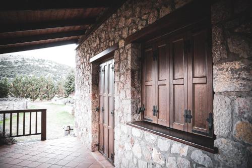 an entrance to a stone building with a door at Mont Valley Boutique Chalets in Arachova