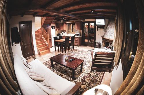 a living room with a white couch and a table at Mont Valley Boutique Chalets in Arachova
