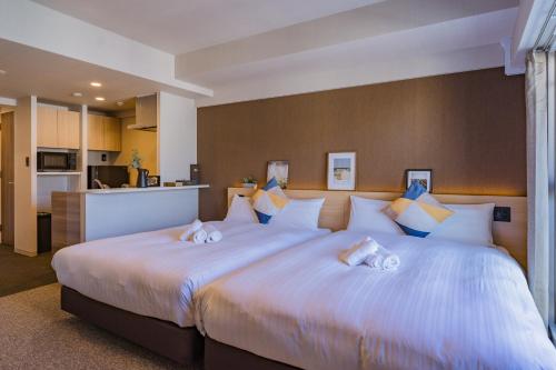 Postel nebo postele na pokoji v ubytování Apartment Hotel 11 Shinsaibashi 3