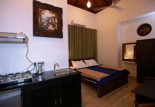a small bedroom with a bed and a sink at Maharagama 5BR bungalow 1BR USD 21 per night in Maharagama