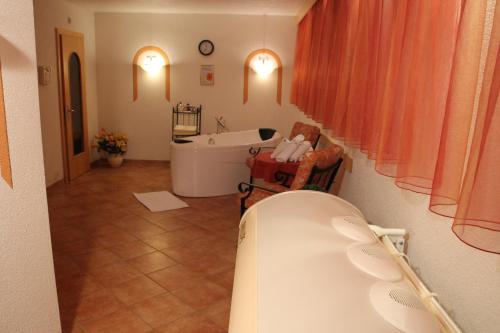 a bathroom with a bath tub and a bath tub at Landhaus Grünberg in Obsteig