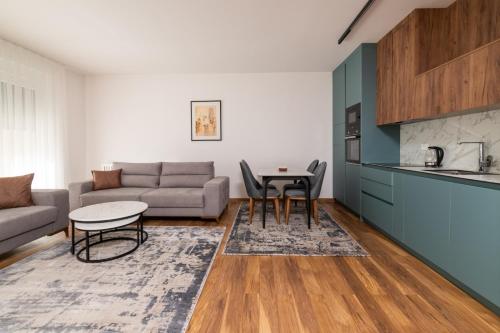 a living room with a couch and a table at Emery Apartments in Pristina
