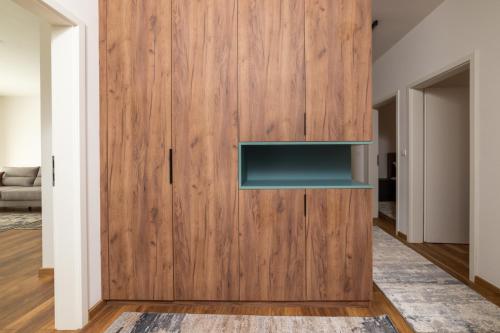 a large wooden cabinet in a living room at Emery Apartments in Pristina