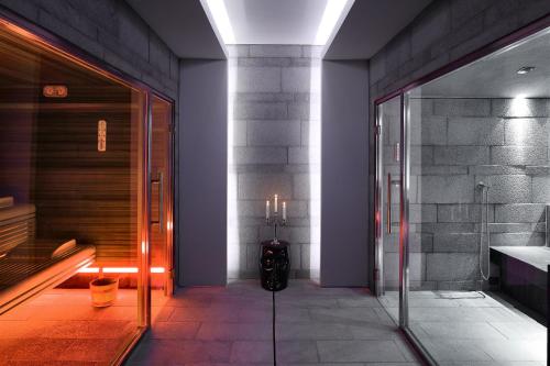a hallway with a glass door with a suitcase in it at La Suite Boutique Hotel in Procida